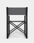 The Harbour Pacific Folding Chair - Black Teak features a black foldable frame with a rectangular fabric backrest and seat, shown from the back against a white background. Its modern outdoor design includes crossed support bars.