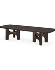 Low, solid wood Flow Coffee Table | Mahogany Rose Brown in a dark finish with two arched, sculptural legs.