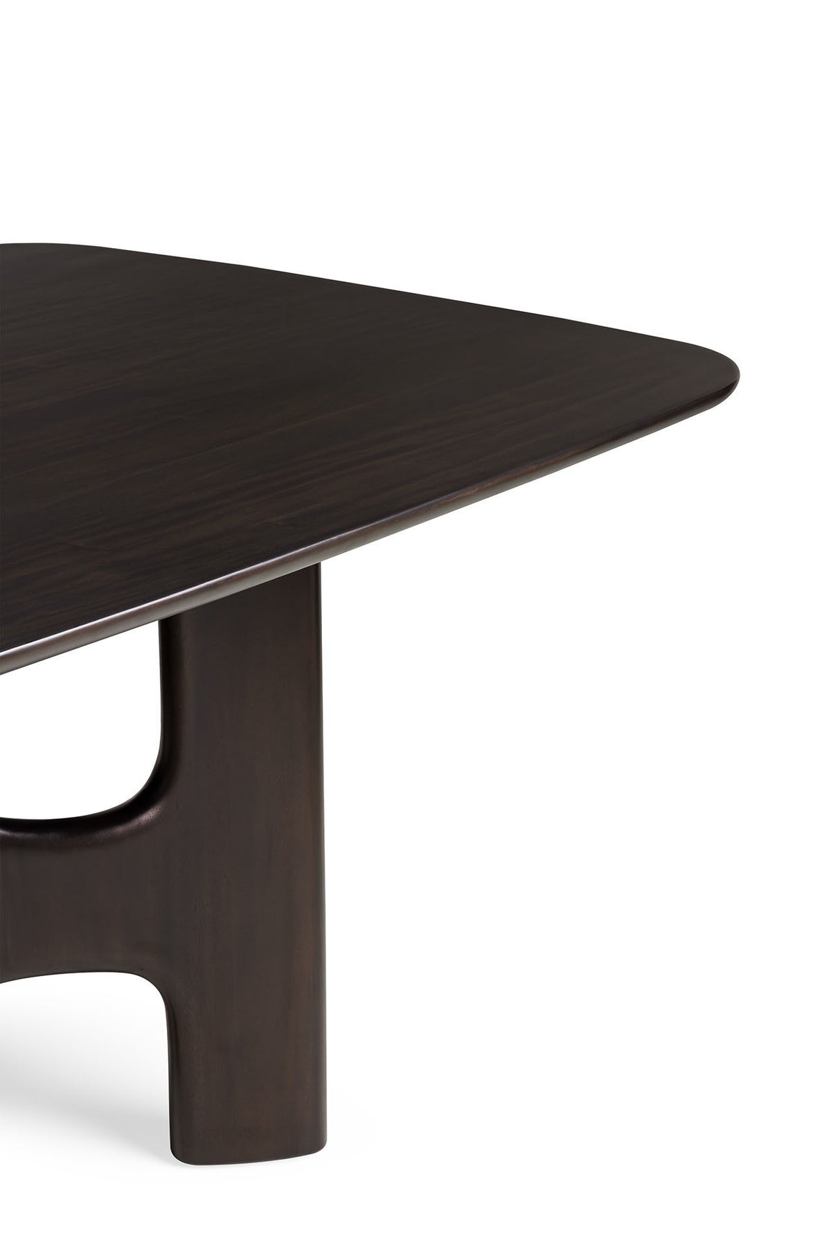 A corner of a dark Mahogany Rose Brown Ethnicraft Flow Dining Table, featuring a smooth, rounded edge and a wide, curved support leg.