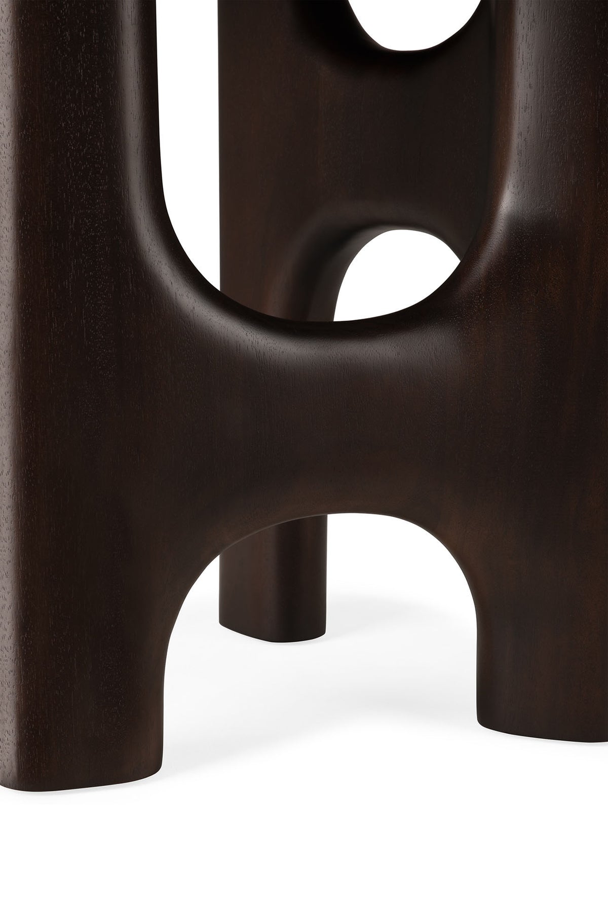 Close-up of the Flow Side Table by Ethnicraft, featuring dark wood legs with smooth, rounded edges and arch-shaped cutouts, highlighting the timeless elegance of this solid mahogany piece against a white background.