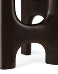 Close-up of the Flow Side Table by Ethnicraft, featuring dark wood legs with smooth, rounded edges and arch-shaped cutouts, highlighting the timeless elegance of this solid mahogany piece against a white background.