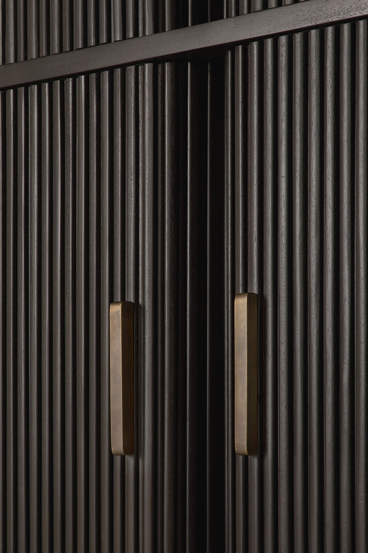 Close-up of dark wooden cabinet doors with vertical grooves and two rectangular brass handles, highlighting the texture and modern design of the Ethnicraft Roller Max Filing Cabinet—an elegant office storage solution.