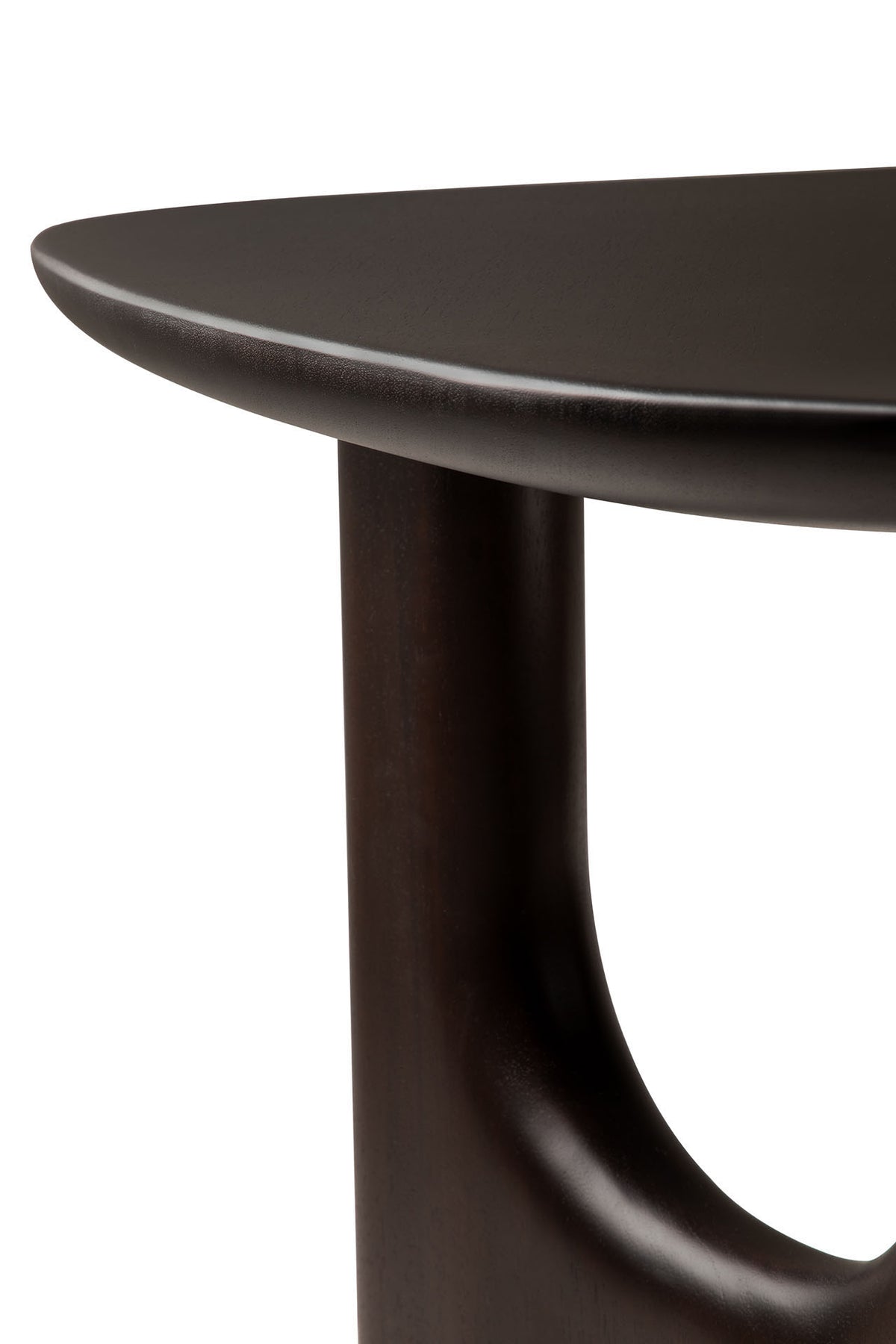 Close-up of the Ethnicraft Flow Side Table, highlighting its dark wooden finish, rounded tabletop edge, and thick, curved leg with smooth, polished surfaces.