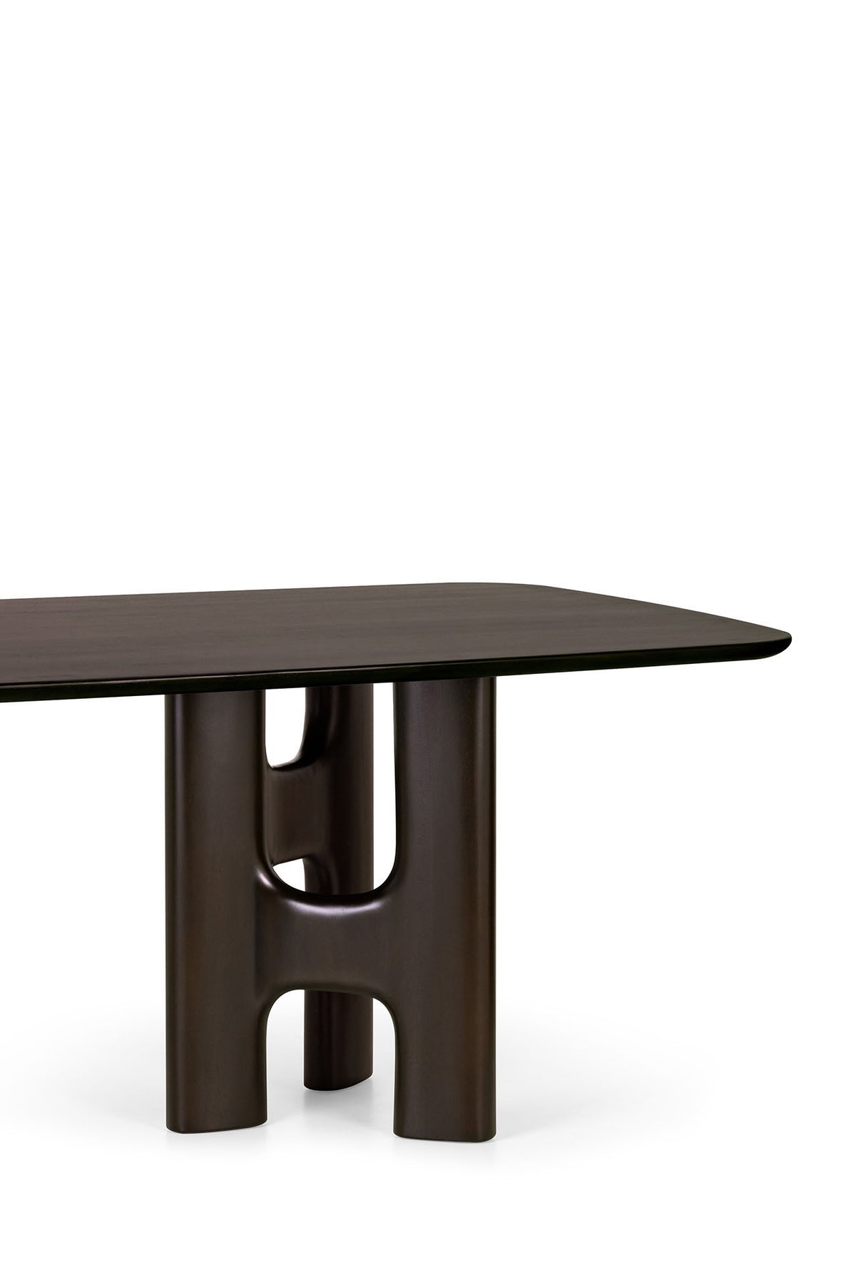 An Ethnicraft Flow Dining Table | Mahogany Rose Brown, featuring a rectangular dark brown top supported by a thick, sculptural H-shaped base.