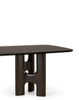 An Ethnicraft Flow Dining Table | Mahogany Rose Brown, featuring a rectangular dark brown top supported by a thick, sculptural H-shaped base.