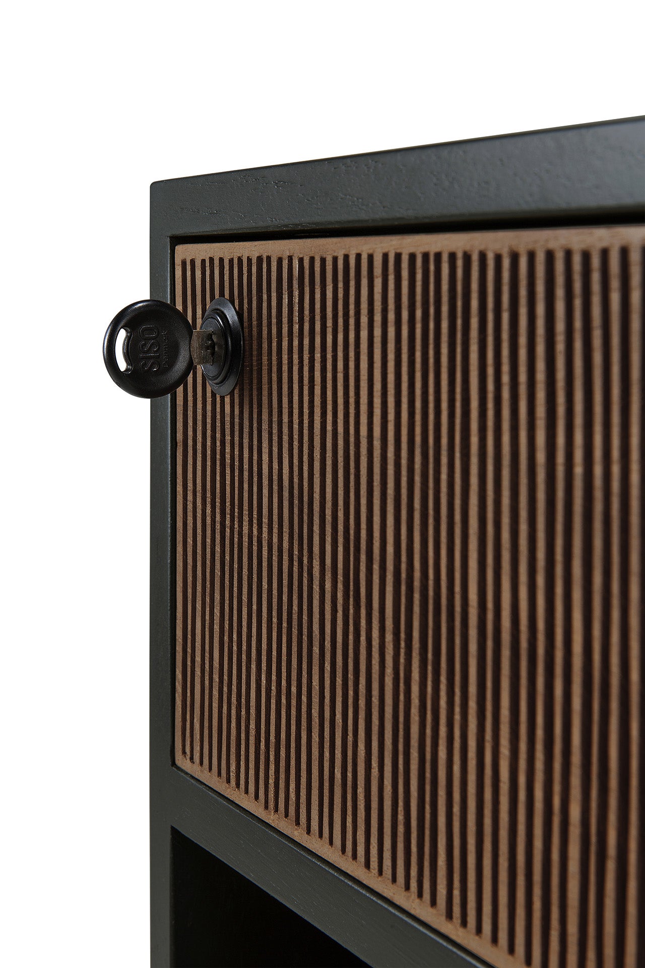 Close-up of a solid teak cabinet from Ethnicraft’s Oscar Drawer Unit, featuring vertical wood grooves and a black lock with a key inserted into the upper left corner of the cabinet door—an elegant office storage solution.