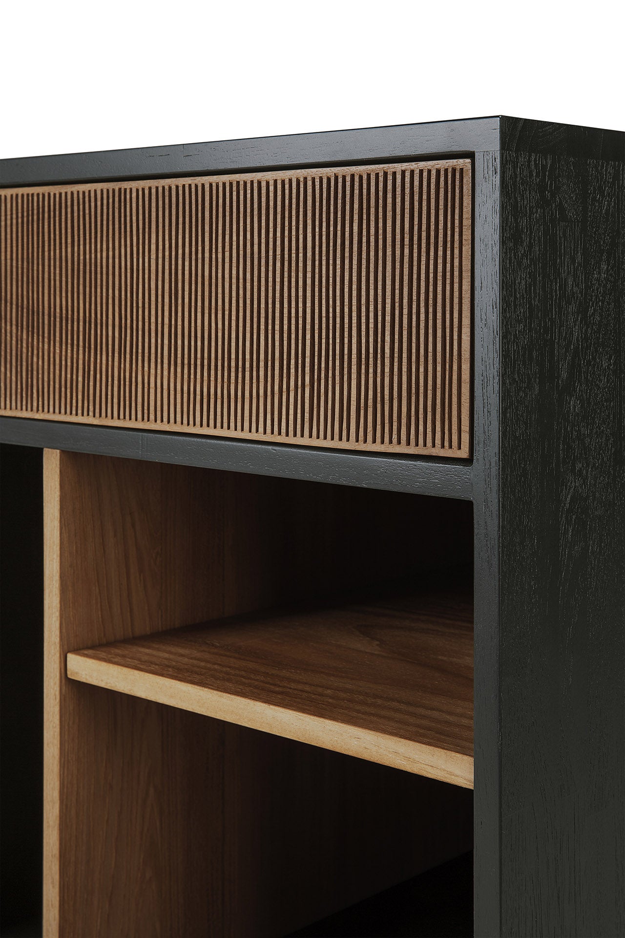 Close-up of the Ethnicraft Oscar Drawer Unit—a modern wooden cabinet featuring a grooved drawer front, black outer frame, and open shelves with natural wood finishes. Expertly crafted from solid teak, its design showcases clean lines and contrasting wood tones, making it ideal for stylish office storage.