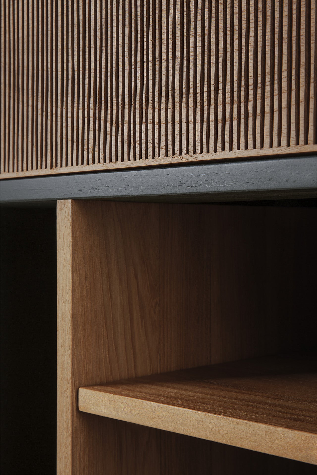 Close-up of the Ethnicraft Oscar Drawer Unit, showcasing its ribbed vertical panel above an open shelf—ideal for stylish office storage—and highlighting the natural wood grain and texture.