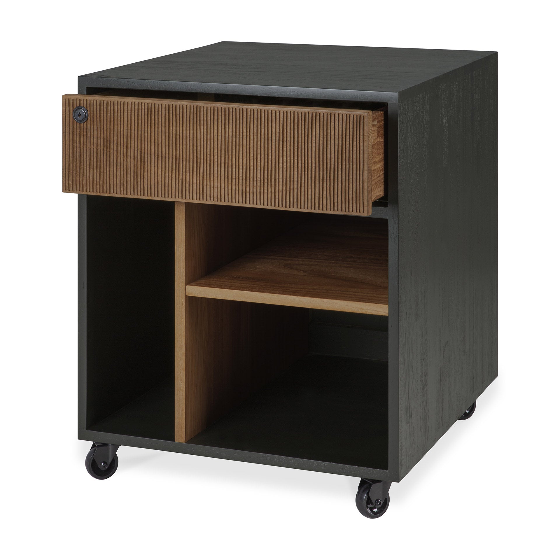The Oscar Drawer Unit by Ethnicraft is a contemporary black and wood rolling storage cart, skillfully crafted with solid teak details. It includes a ribbed-front drawer, an open shelf, and two vertical compartments for stylish office organization—all set atop four caster wheels for easy mobility.