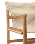 Close-up of the Ethnicraft Safari Lounge Chair featuring a light-colored fabric backrest and seat, with clean lines and a minimalist design set against a white background.