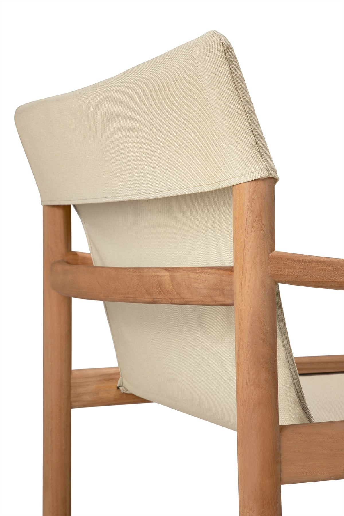 A close-up of the Safari Lounge Chair by Ethnicraft, featuring a light wood frame and beige fabric backrest, is shown from an angle behind and to the side—an embodiment of the brand’s timeless elegance.