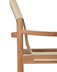 Side view of the Safari Lounge Chair by Ethnicraft, featuring a wooden frame and light beige fabric backrest and seat, highlighting its simple, minimalist design against a white background.