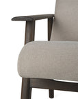 Close-up of the Ethnicraft Aspekt Lounge Chair - Dark Brown Teak, featuring light beige fabric upholstery and dark wooden armrests and legs, set against a plain white background.