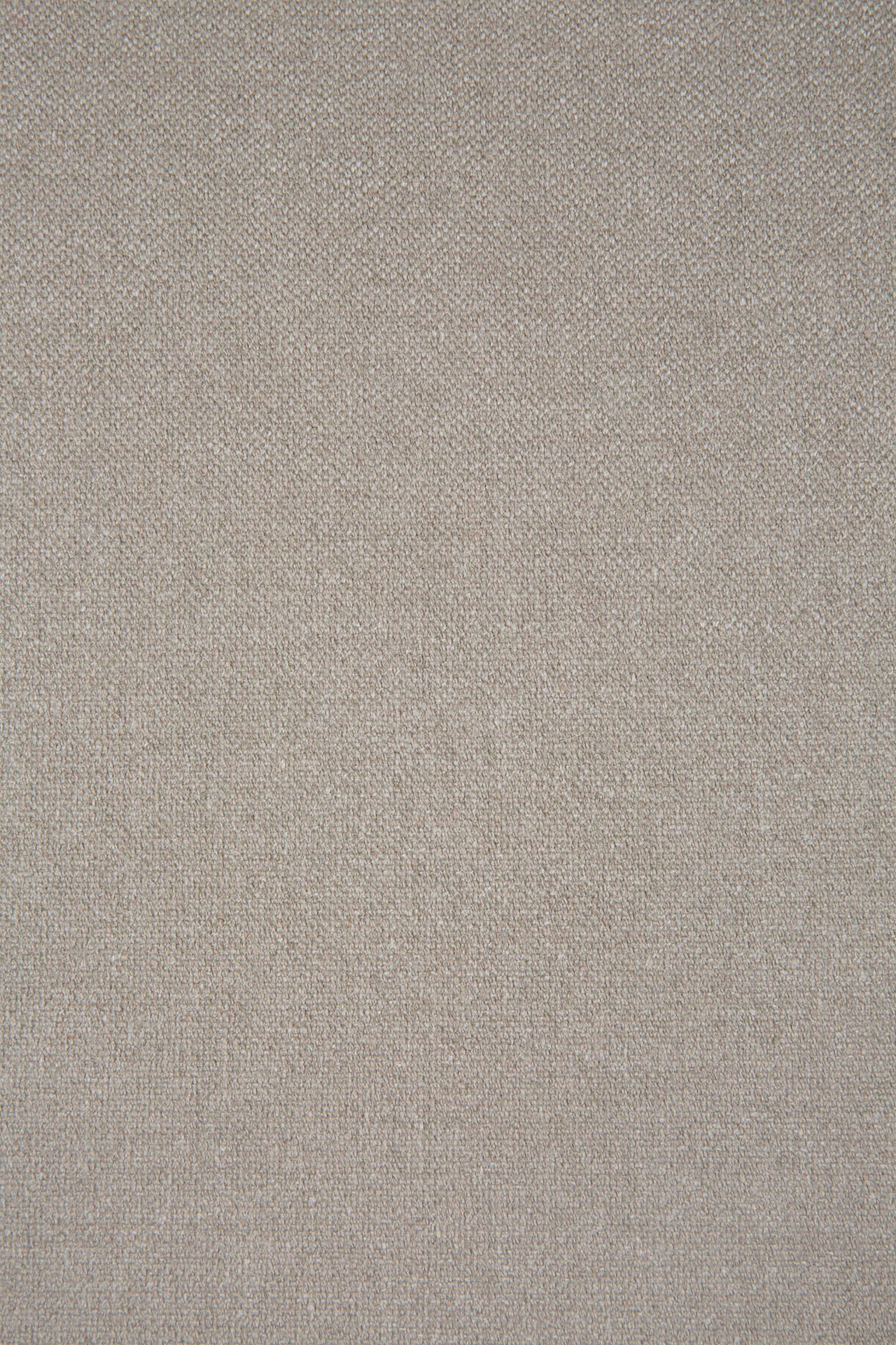 A close-up of the textured beige fabric with a subtle diagonal weave pattern used on Ethnicraft’s Aspekt Lounge Chair – Dark Brown Teak highlights its soft, uniform surface with slight thread and color variations.