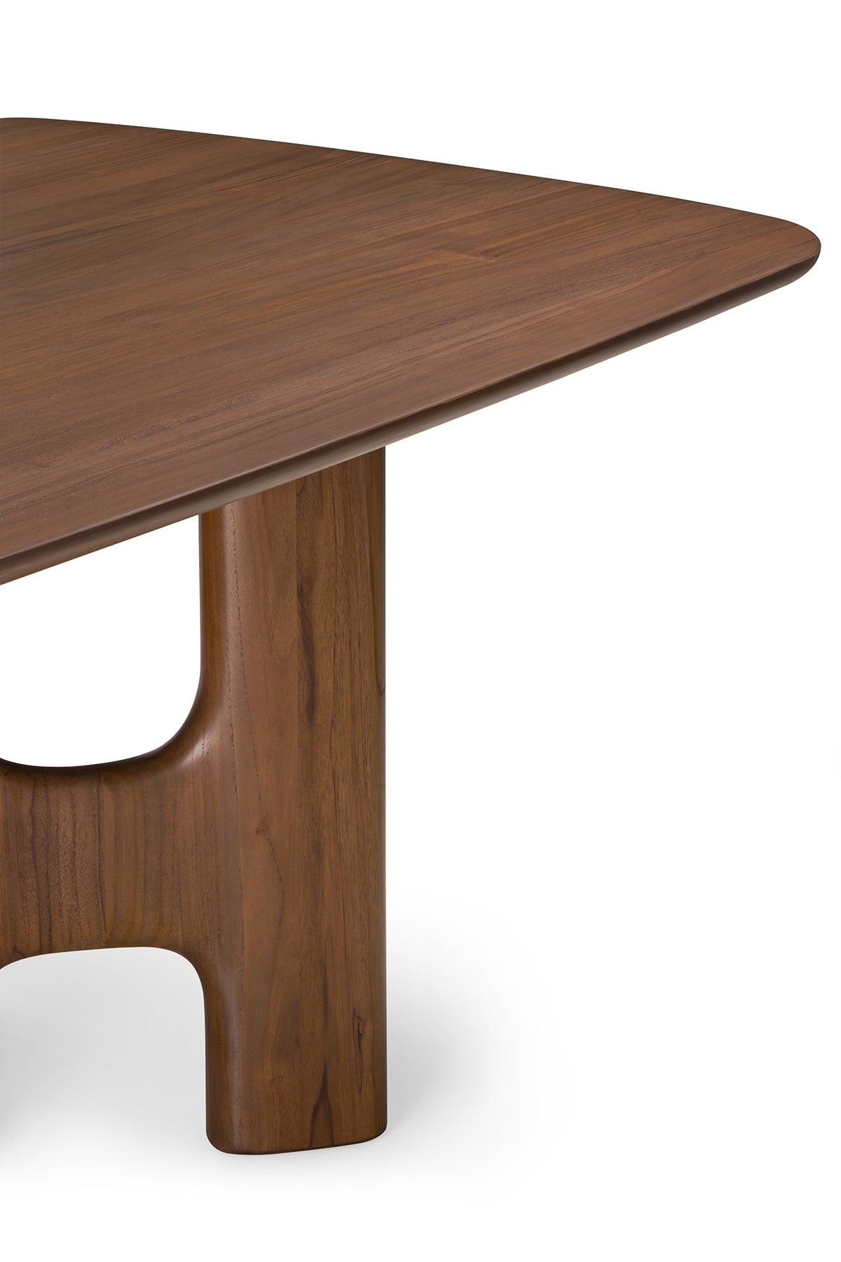 Close-up of an Ethnicraft Flow Dining Table | Teak Wild Brown, featuring a brown wood surface with a smooth, rounded corner and a sculptural, curved pedestal base.