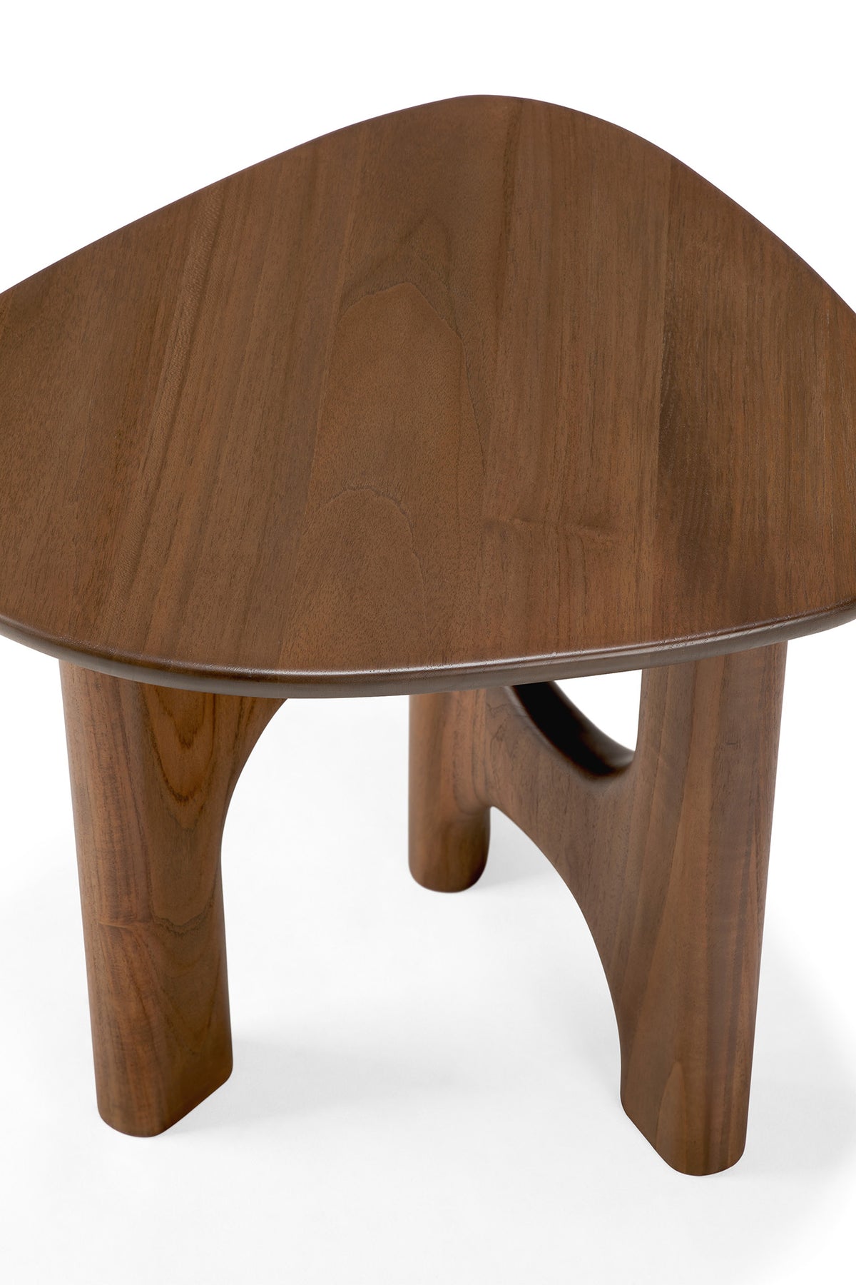The Flow Side Table by Ethnicraft is a small, triangular wooden coffee table with rounded edges and three sturdy legs. Set against a white background, this piece evokes the timeless appeal of vintage modern furniture.