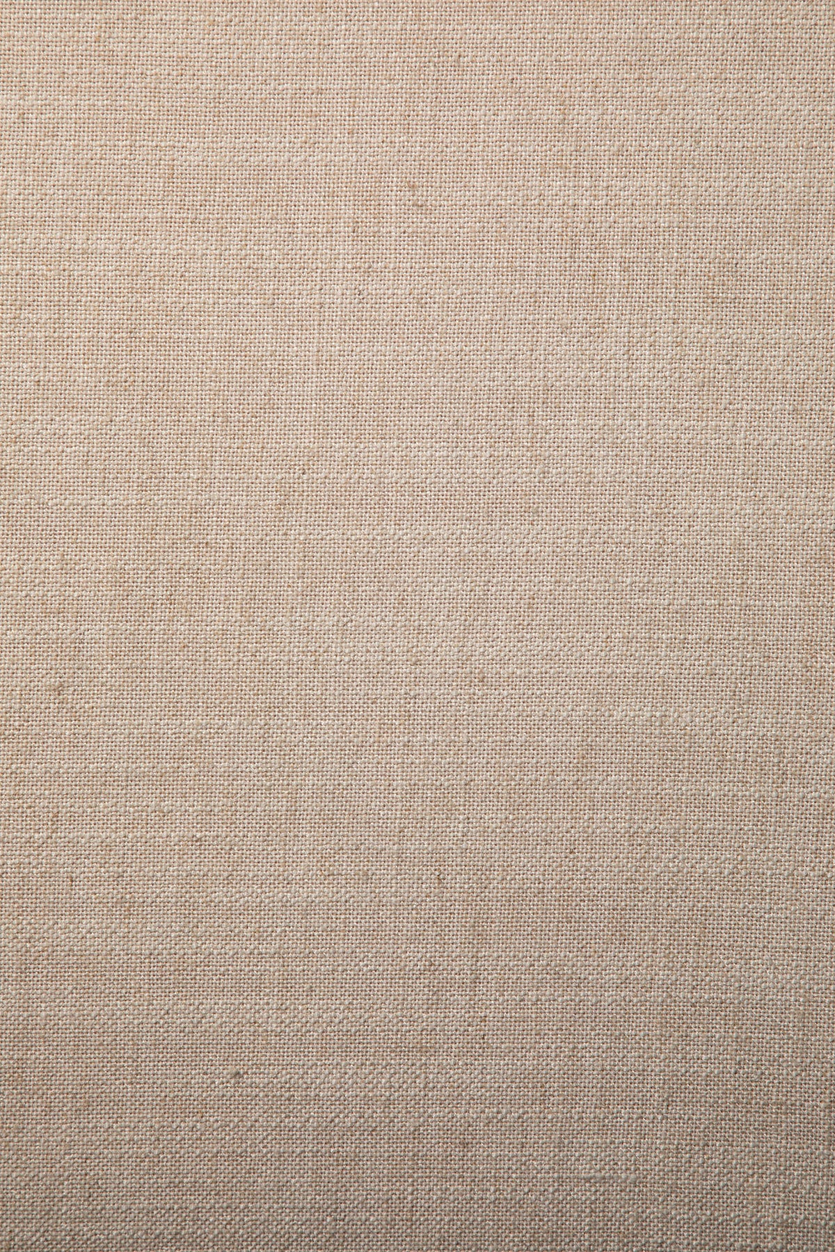 Close-up view of the Roan Lounge Chair | Flax by Ethnicraft, showcasing its plain beige fabric with a visible woven texture and subtle horizontal and vertical lines. The natural, slightly rough surface offers an understated elegance—making it an ideal upholstery choice to complement the solid teak craftsmanship of the chair.