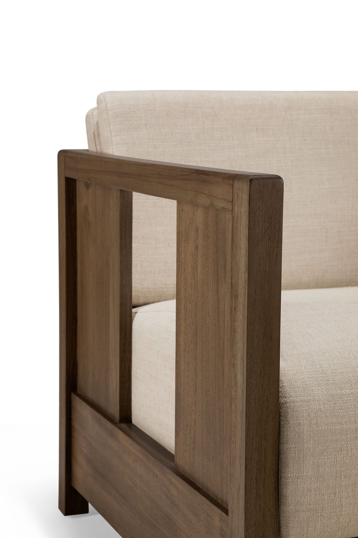 Close-up of the Roan Lounge Chair | Flax by Ethnicraft, showcasing a beige upholstered seat with a wooden frame and armrest, featuring clean lines and a minimalist design.
