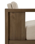 Side view of the Ethnicraft Roan Lounge Chair | Flax, featuring a modern solid teak frame with rectangular armrests and light beige upholstered cushions, highlighting its clean lines and minimalist design.