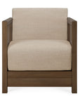 Front view of the Roan Lounge Chair | Flax by Ethnicraft, featuring a solid teak wooden frame and beige upholstered seat and backrest. The boxy, minimalist design embodies timeless style and durable craftsmanship.