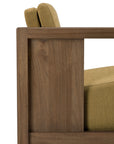 Close-up of the side of the Roan Lounge Chair | Amber by Ethnicraft, showcasing a light brown solid teak frame with mustard yellow upholstered seat and back cushions. This chair beautifully combines natural materials with modern comfort.