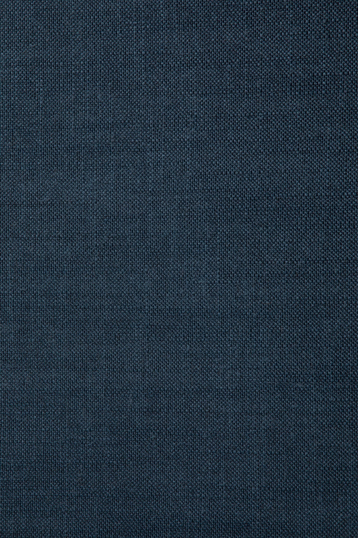 Close-up of the Ethnicraft Roan Lounge Chair | Ink shows a dark blue knitted fabric with a fine, even texture and subtle vertical patterns. The material appears soft and smooth, making it an excellent choice for upholstering this vintage-inspired lounge chair.
