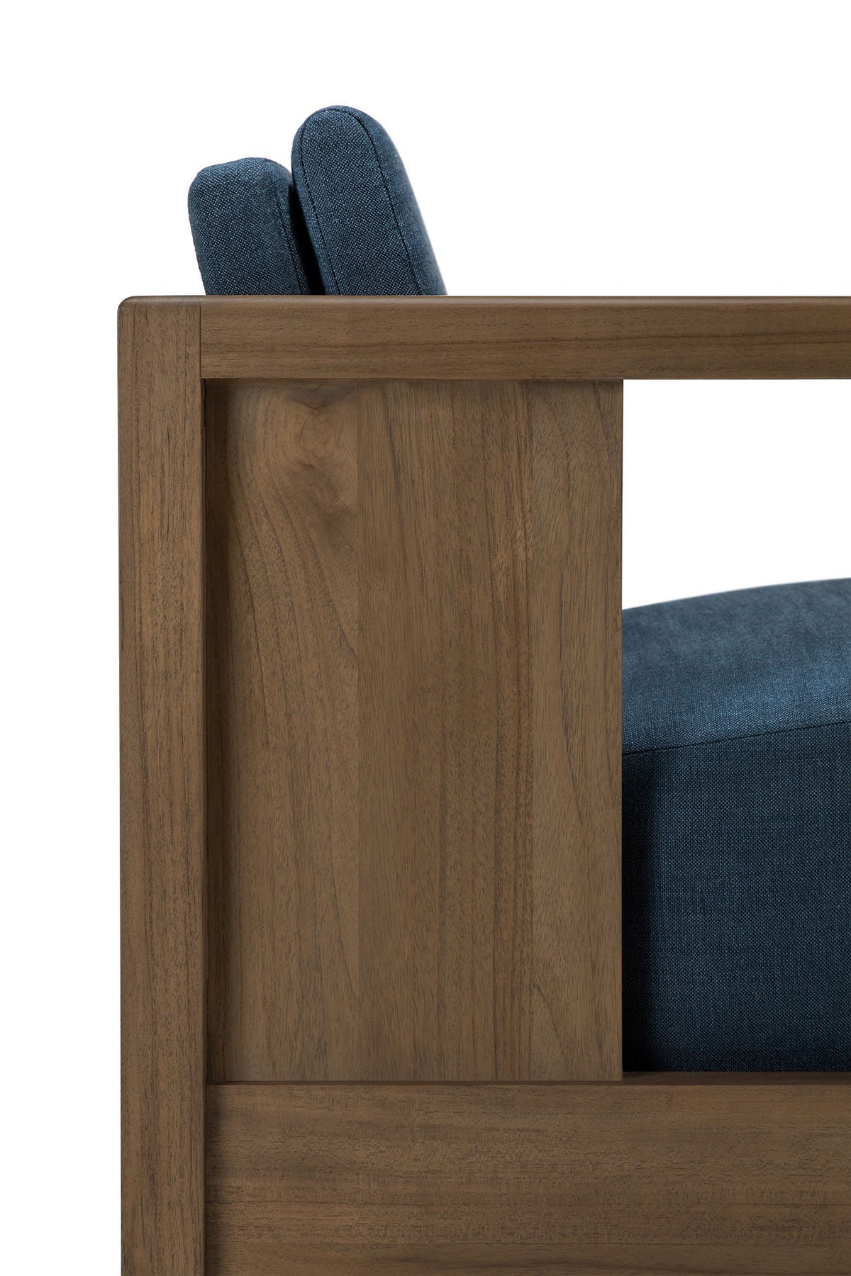 Close-up side view of the Ethnicraft Roan Lounge Chair | Ink, featuring blue upholstered seat and back cushions on a sleek wooden frame that highlights the chair’s modern design, wood grain detailing, and vintage-inspired charm.