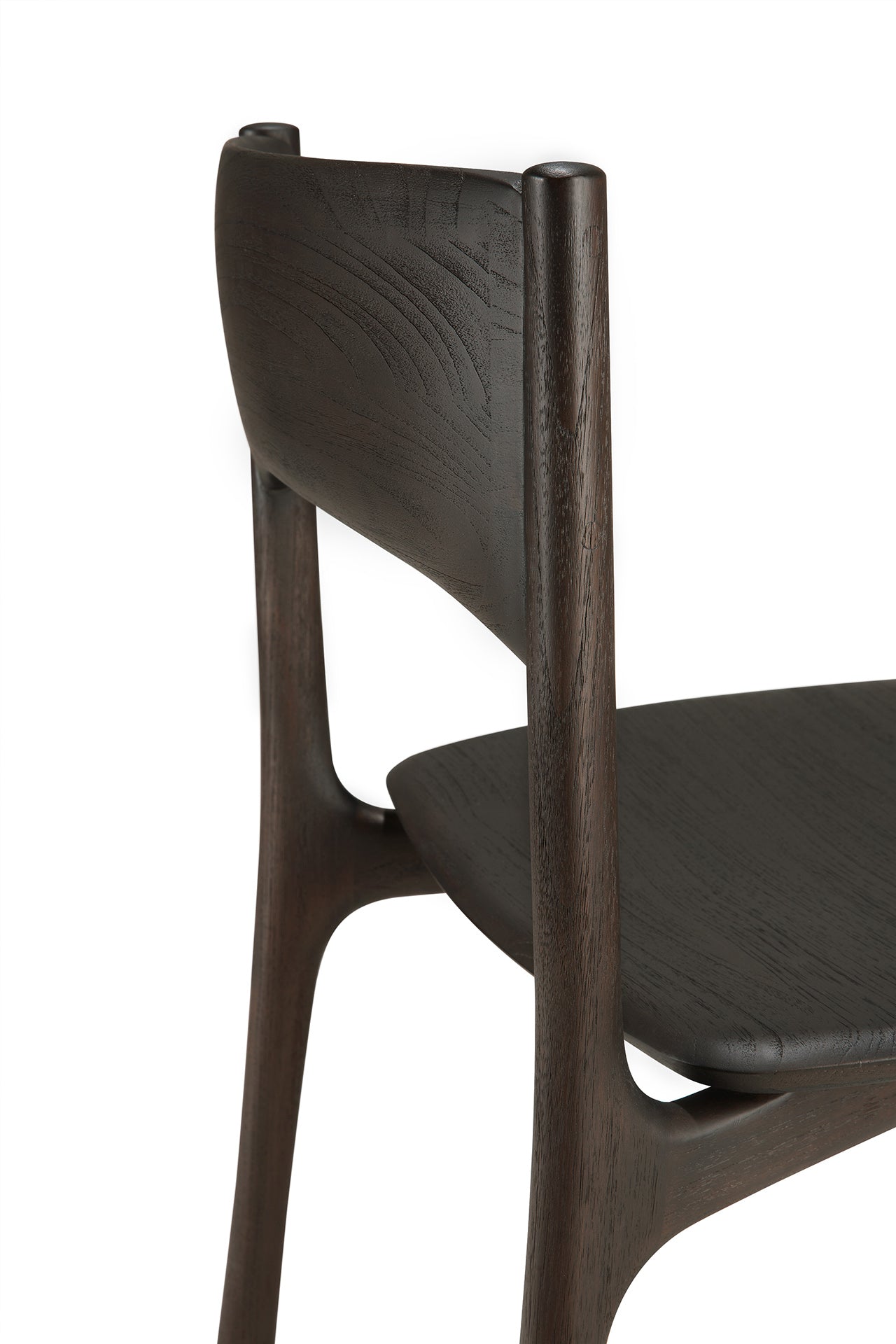 A close-up view of the Ethnicraft PI Dining Chair - Teak Dark Brown highlights its solid teak construction, smooth curves, and minimalist modern design against a white background.