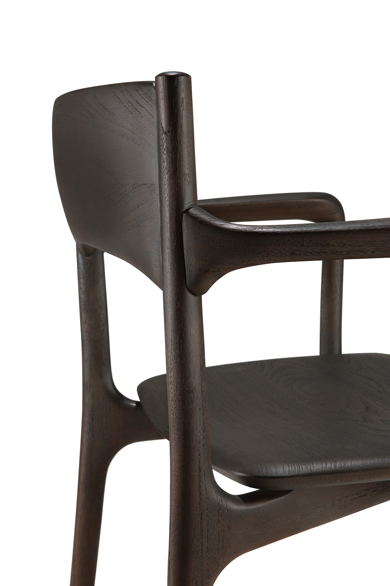 A close-up of the Ethnicraft PI Dining Chair – Teak Dark Brown with arms, highlighting its curved backrest, armrest, and seat crafted from dark wood, set against a white background.