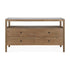 The Spindle Dresser by Ethnicraft features a minimalist design in natural teak, with four drawers and an open shelf, inspired by the brand’s signature style and crafted from sustainably sourced wood.