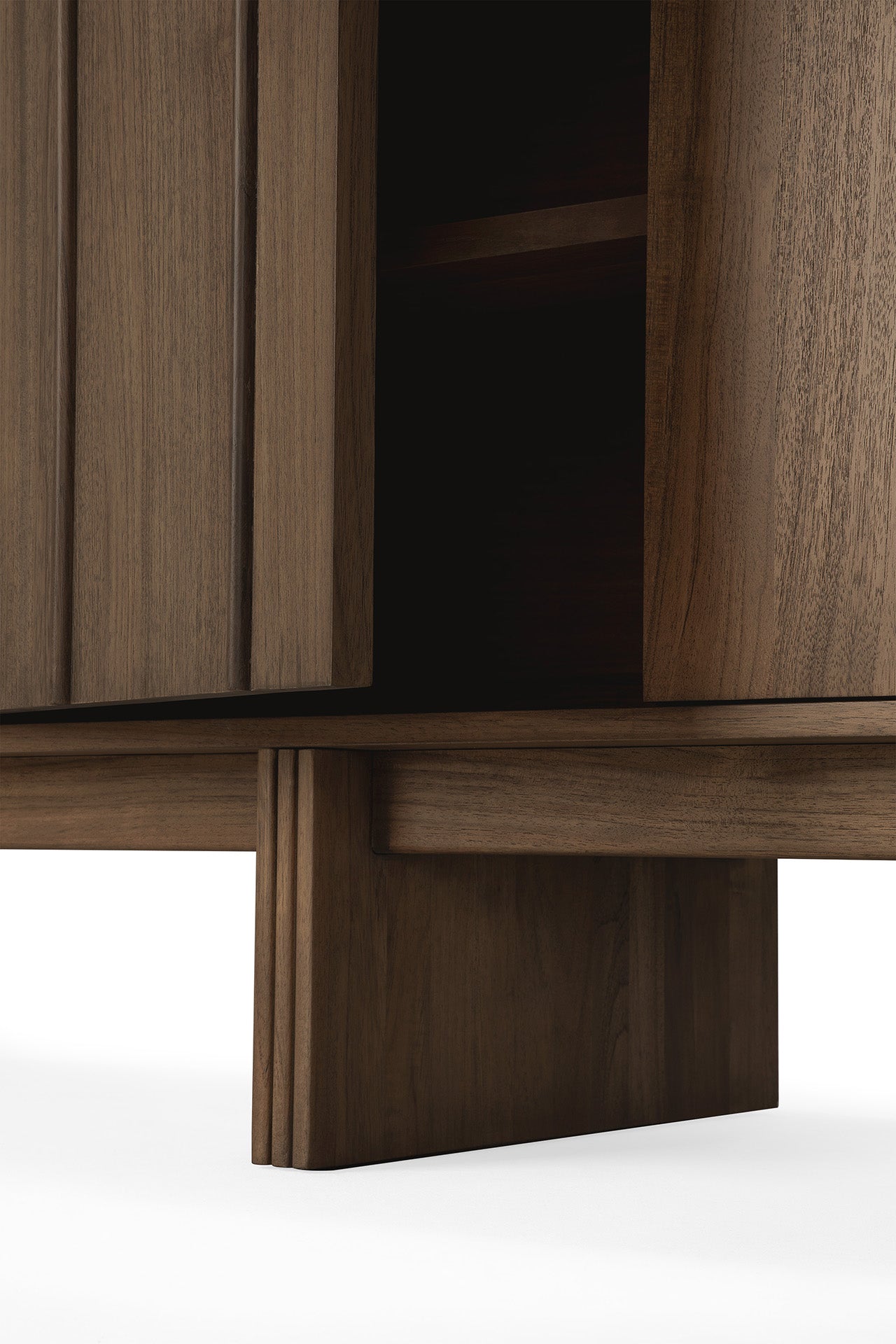 Close-up of the Ethnicraft Pillar Sideboard - Teak Wild Brown, featuring a partially open door that reveals its smooth wood grain and sturdy legs, set against a white background.