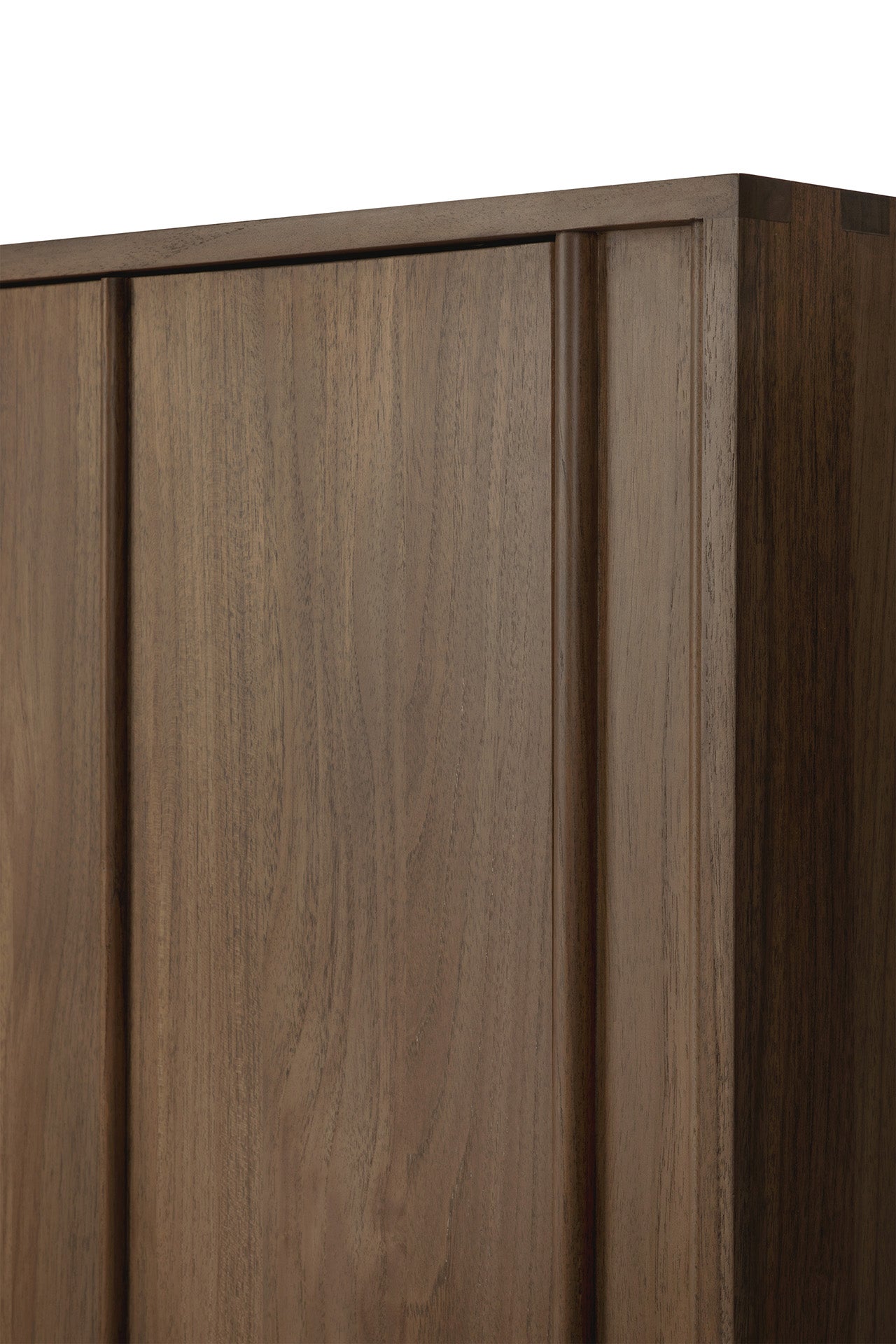 Close-up of the top corner of Ethnicraft's Pillar Sideboard - Teak Wild Brown, highlighting its smooth finish, vertical panel details, and the natural brown teak wood with visible grain patterns.