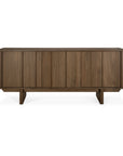 The Ethnicraft Pillar Sideboard - Teak Wild Brown features a modern, minimalist look with vertical panel detailing, a dark brown teak finish, and four short legs inspired by mid-century design.