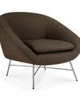 Dark brown upholstered Barrow Lounge Chair - Paon by Ethnicraft with a rounded back and slim metal legs.