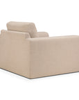 The Ease Lounge Chair by Ethnicraft is a beige, modern armchair with a boxy design and soft fabric upholstery, featuring high density foam for comfort; shown from the rear side angle against a white background.