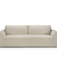 A light beige three-seater Ethnicraft Ease sofa with a low-profile frame and two back cushions in Leche upholstery.