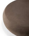Close-up of an Ethnicraft Orb Pouf in fawn nubuck leather with visible stitched seam detail.