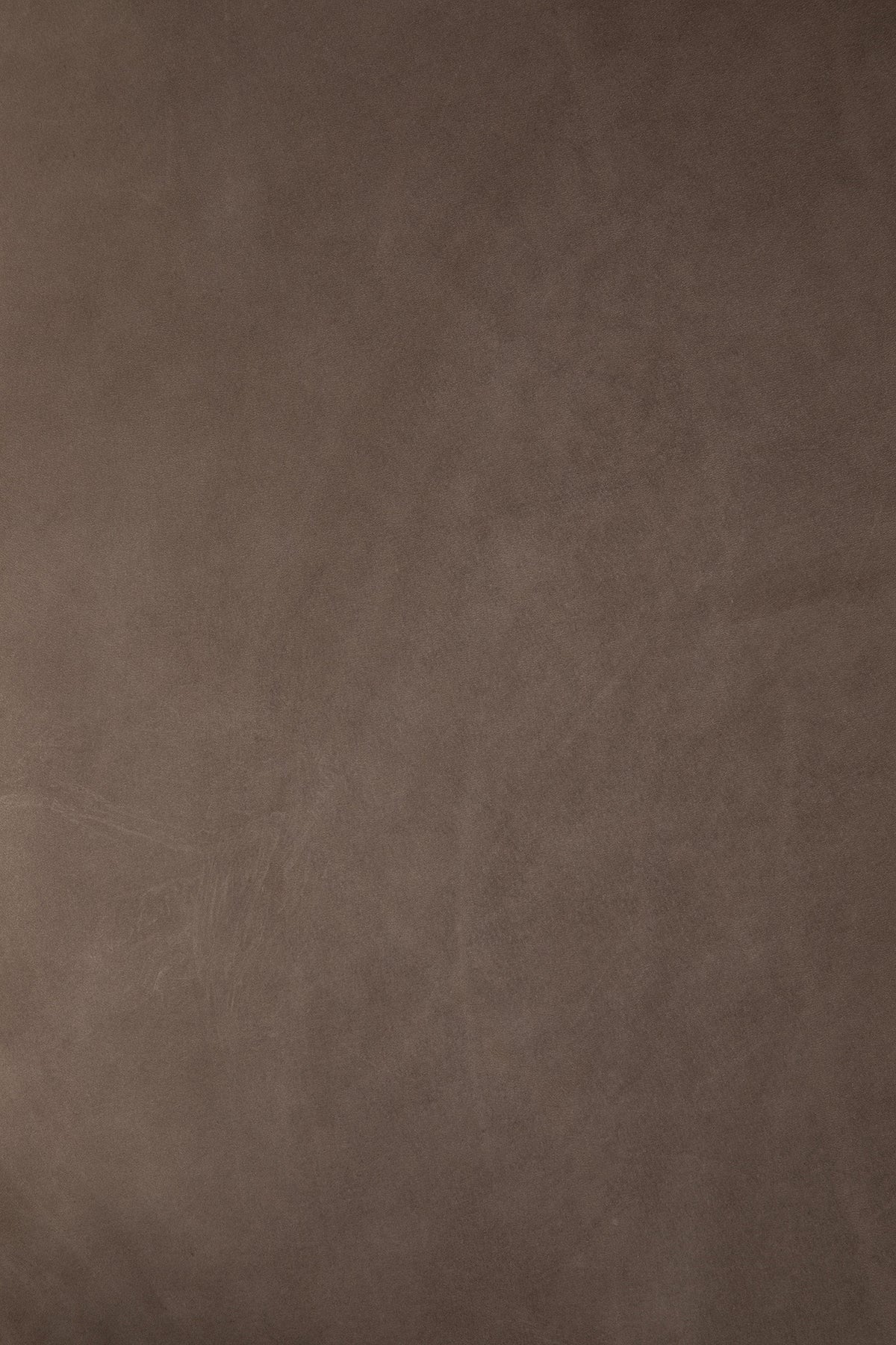 Close-up of the smooth, taupe-brown Fawn Nubuck Leather surface on an Ethnicraft Orb pouf.