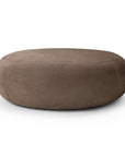 A round, low-profile Ethnicraft Orb Pouf | Fawn Nubuck Leather in muted brown.