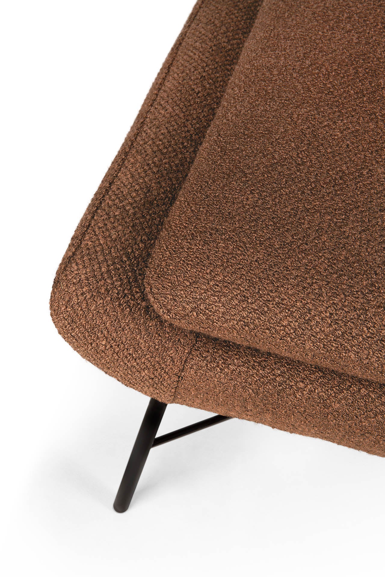 Close-up of the Barrow Footstool - Copper by Ethnicraft, featuring a brown textured upholstered cushion and black metal legs against a white background—a stylish take on vintage-inspired design.