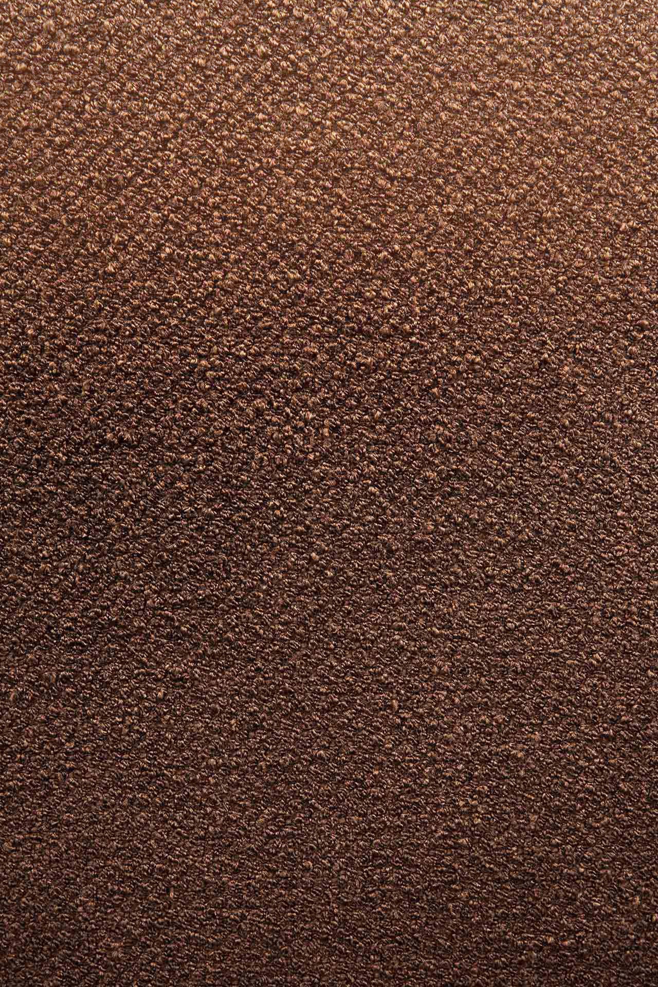 Close-up of the Barrow Footstool - Copper by Ethnicraft, showing its textured brown surface with a grainy, vintage look that highlights the brands signature craftsmanship and rich color variation.