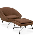 The Ethnicraft lounge chair with a curved backrest pairs with the Barrow Footstool - Copper, both featuring brown upholstery and black metal legs, set against a plain white background.
