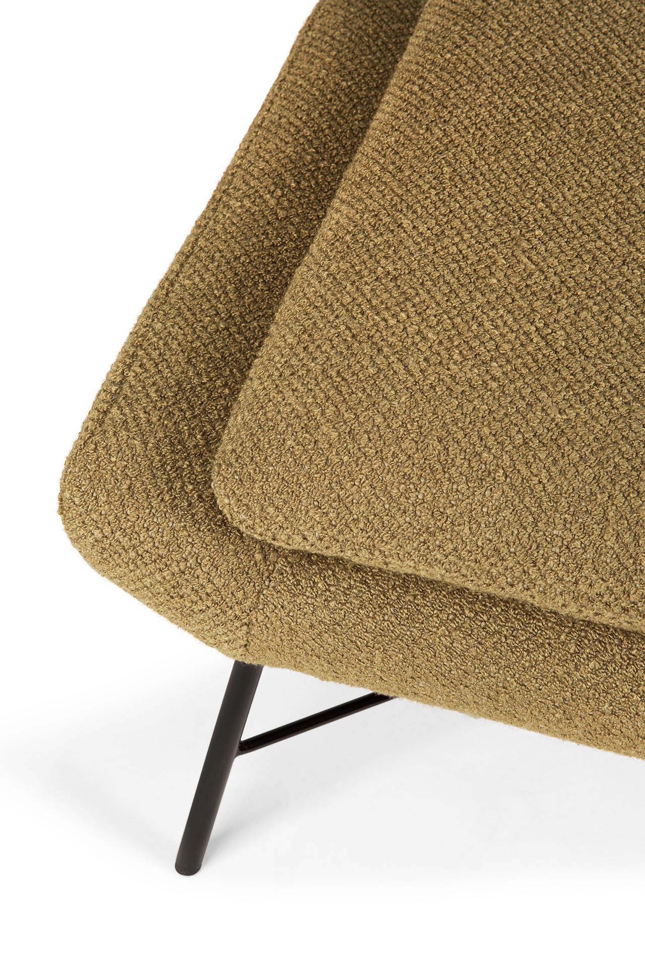 Close-up of the Ethnicraft Barrow Footstool in Ginger, featuring textured fabric, angled lines, black metal legs, and a minimalist design inspired by vintage furniture, shown against a white background.