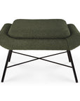 The Barrow Footstool - Pine Green by Ethnicraft is a modern green fabric ottoman with a cushioned top, curved edges, and X-shaped black metal legs—ideal for adding vintage-inspired style to your living space.