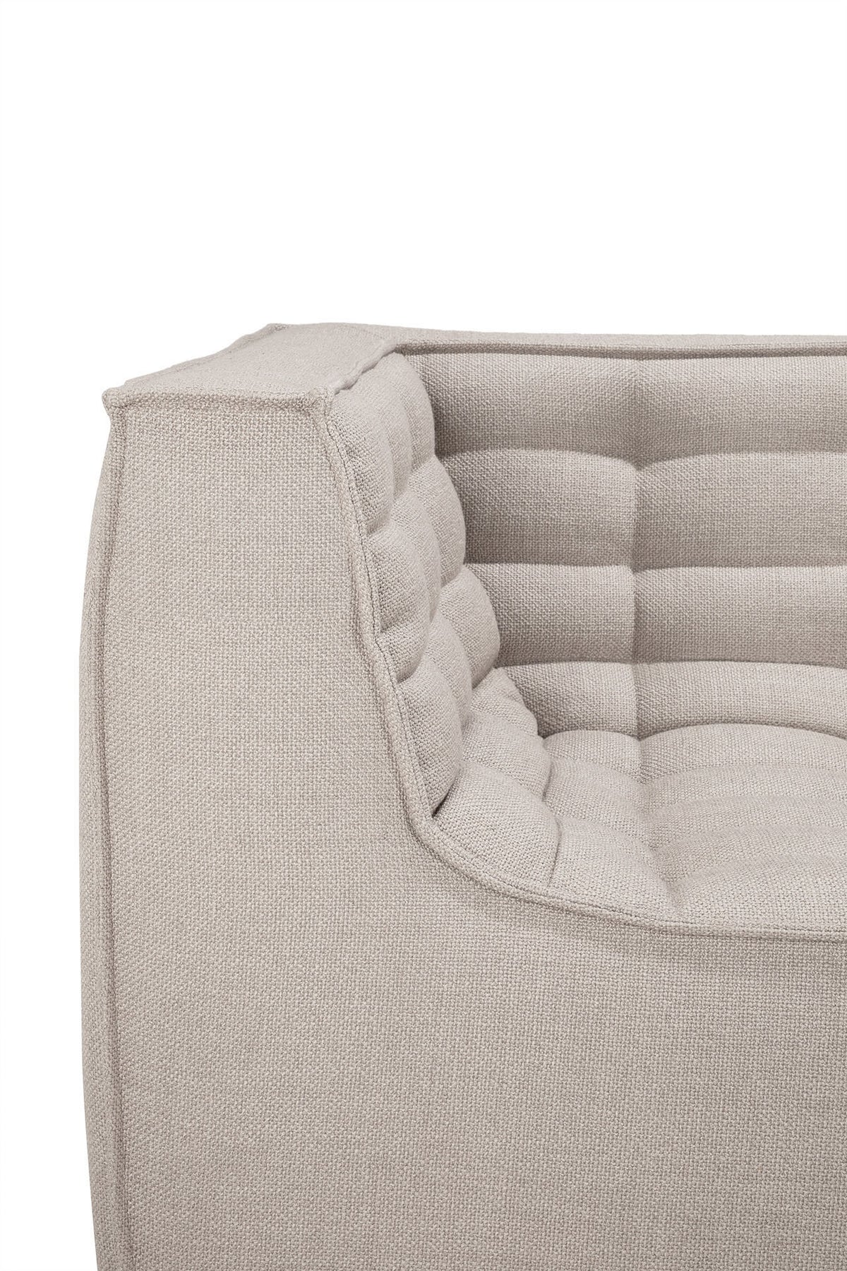 Close-up of the N701 2-Seater Sofa by Ethnicraft in beige, featuring a quilted, cushioned texture and clean, angular lines that highlight its modular design inspired by European craftsmanship.