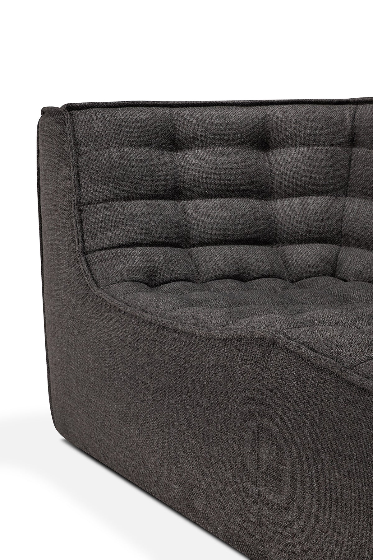 Close-up of the Ethnicraft N701 2-Seater Sofa in Dark Grey, featuring tufted cushioning and a sleek, boxy silhouette inspired by European design, shown against a white background.