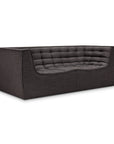 The N701 2-Seater Sofa by Ethnicraft in Dark Grey features a boxy silhouette with a tufted backrest and seat cushion, clean lines, and a minimalist design inspired by European aesthetics.