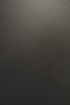 Close-up view of the black aniline leather texture on an Ethnicraft Jack Lounge Chair - Black Leather.