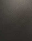 Close-up view of the black aniline leather texture on an Ethnicraft Jack Lounge Chair - Black Leather.