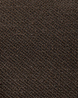 Close-up of a brown textured surface, possibly leather or synthetic material, featuring a fine, pebbled pattern—evocative of the sophisticated finishes found on the Ethnicraft Figur Sofa | 3 Seater, ideal for modern living spaces.